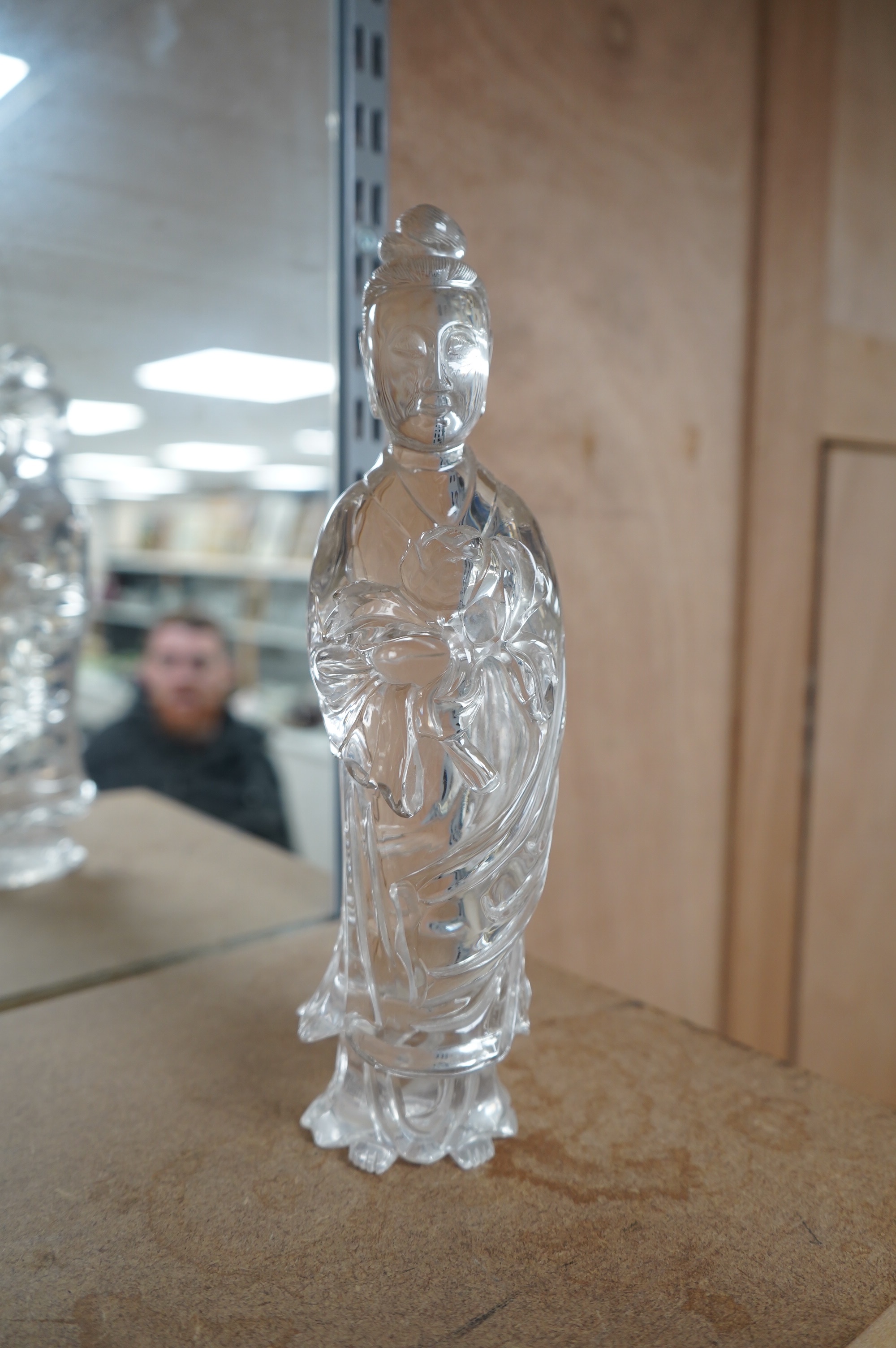 A large Chinese rock crystal figure of a standing lady holding a peony branch, 20th century, 27cm high. Condition - some chips to base